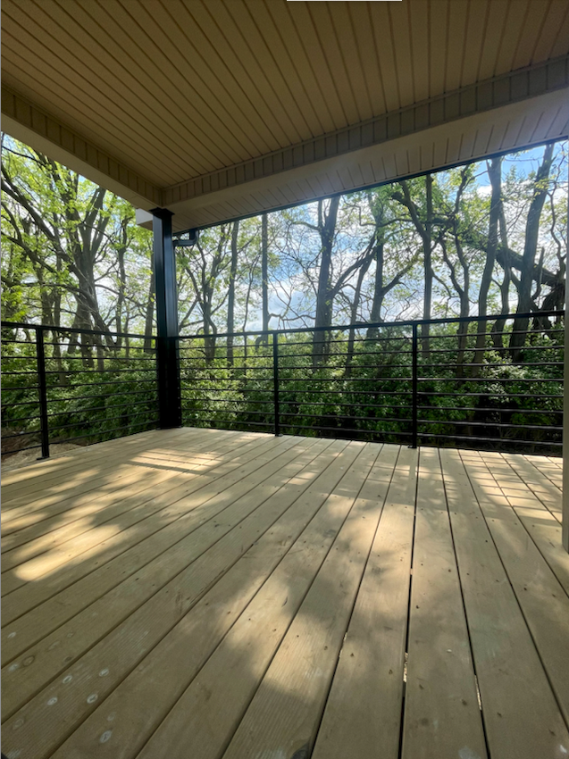 Covered deck with view of trees