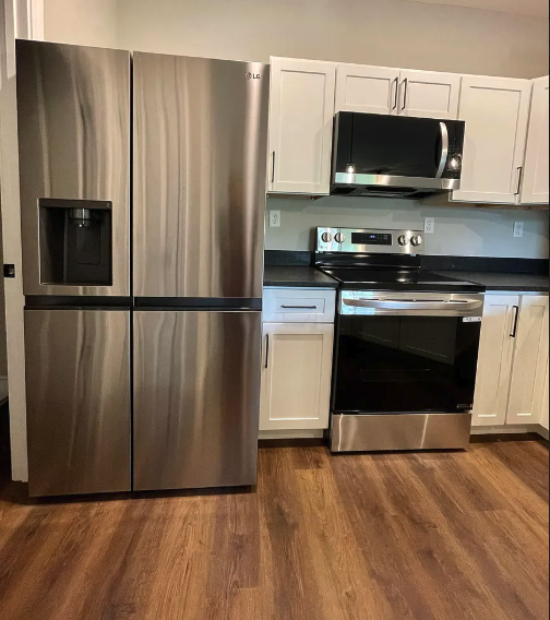 Kitchen with stainless steel refrigerator and appliances